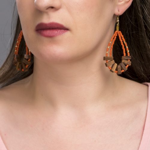 Statement drop earrings that are rustic and daring. An unusual combination of rust coloured glass beads and dark wood.