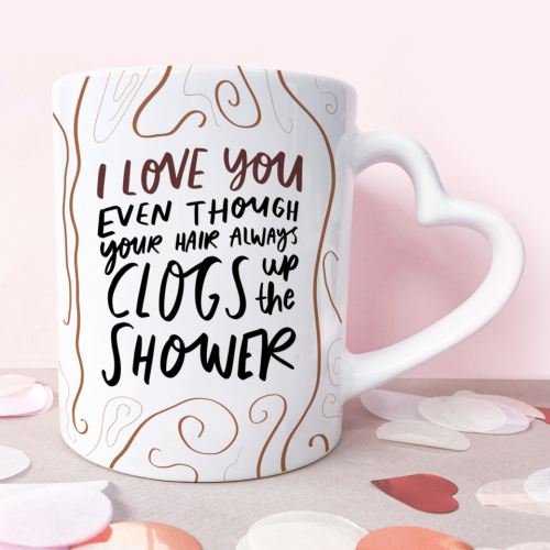 An 11oz Ceramic Mug With A Heart Shaped Handle That Reads 