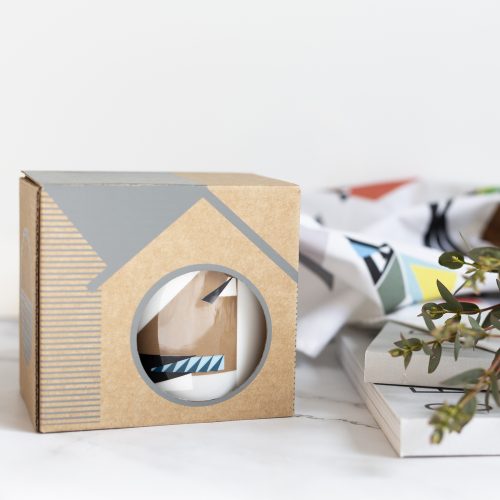 Fine bone china mug with a geometric Jay Print. Mug is in birdbox with part of the design revealed.