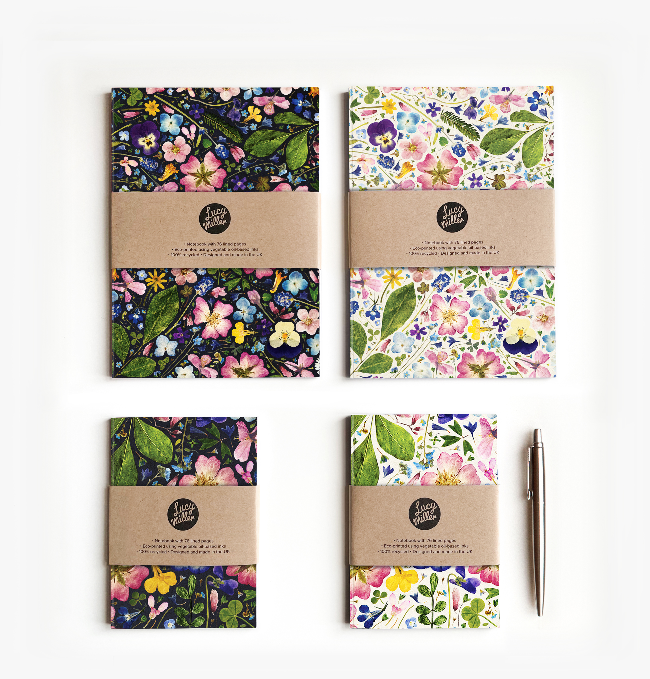 A5 and A6 Floral Notebooks Four pressed flower notebooks on a white background. Each notebook is secured with a kraft belly band. There are two A6 and two A5 notebooks.
