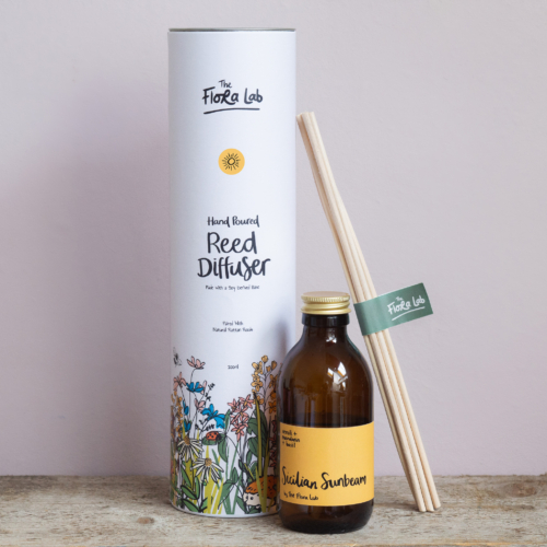 Experience the essence of a Sicilian sunbeam with our handcrafted Citrus Sicilian Sunbeam Reed Room Diffuser. Expertly poured and made with a soy-derived formula, this diffuser is ideal for enhancing your space during the summer months and is long lasting, lasting up to ten weeks. Immerse yourself in the refreshing blend of sun-ripened oranges, zesty lemons, delicate neroli, and fresh basil, creating a romantic atmosphere wherever it's placed. Our best-selling, long-lasting diffuser is designed to evoke feelings of happiness and enjoyment, making it the perfect companion for sunny days and cozy evenings alike. Perfectly protected in a sustainable beautiful FSC botanical box.