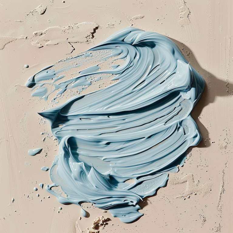 sapphira_cleansingwash_texture_on_a_beige-bkgnd3_md Blue cream product smear of Sapphira Botanical Cleansing Wash on beige background