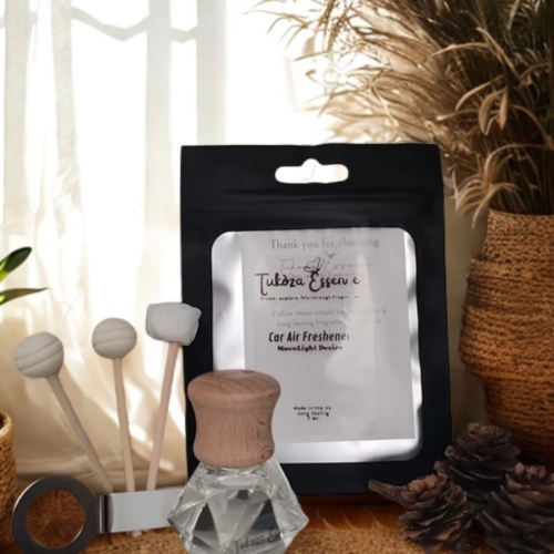 Moonlight Desire car air freshener on a rustic table with three diffuser reeds – elegant and handcrafted design