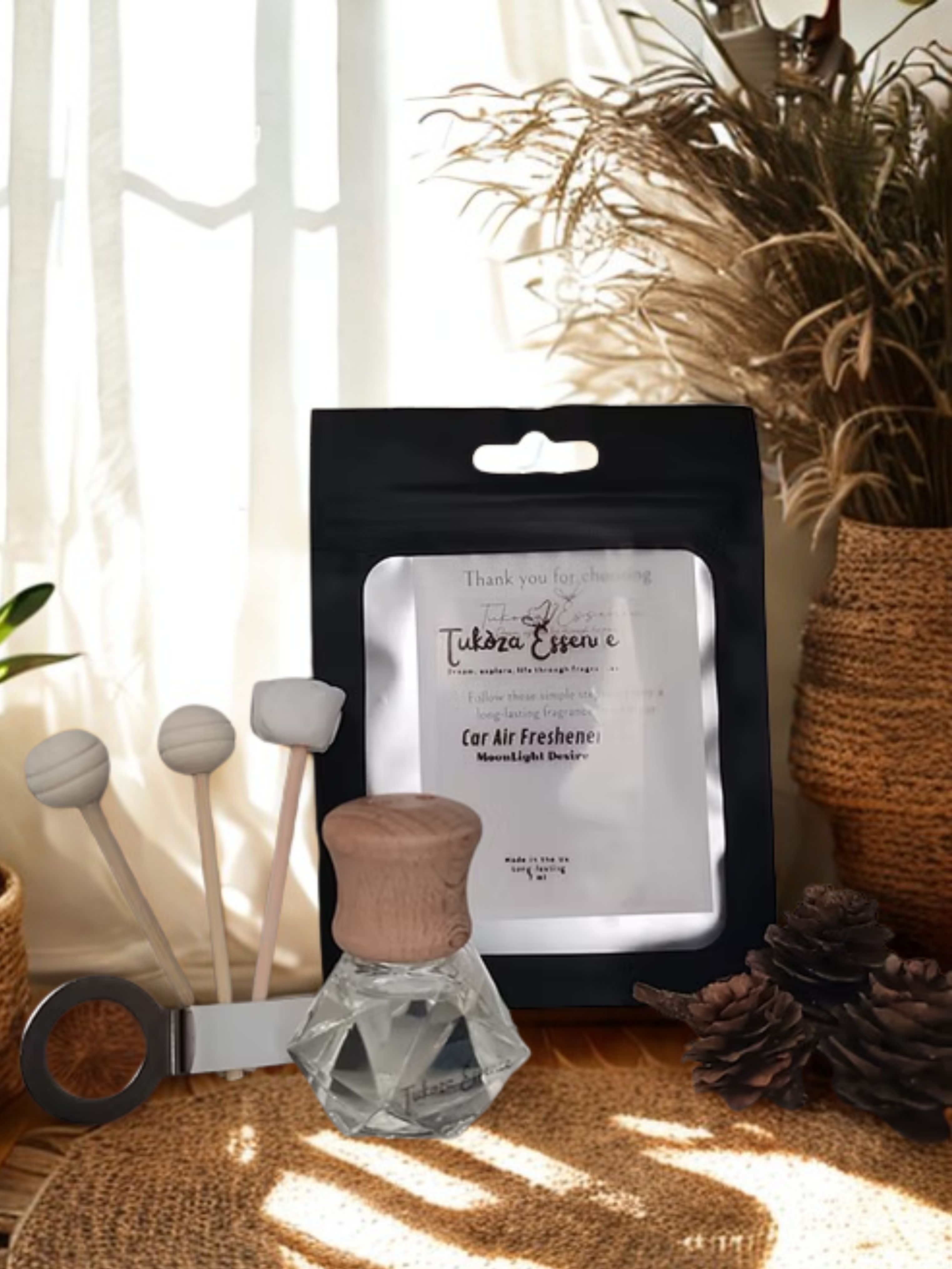Moonlight Desire Car Air Freshener – Elegant Rustic Display Moonlight Desire car air freshener on a rustic table with three diffuser reeds – elegant and handcrafted design