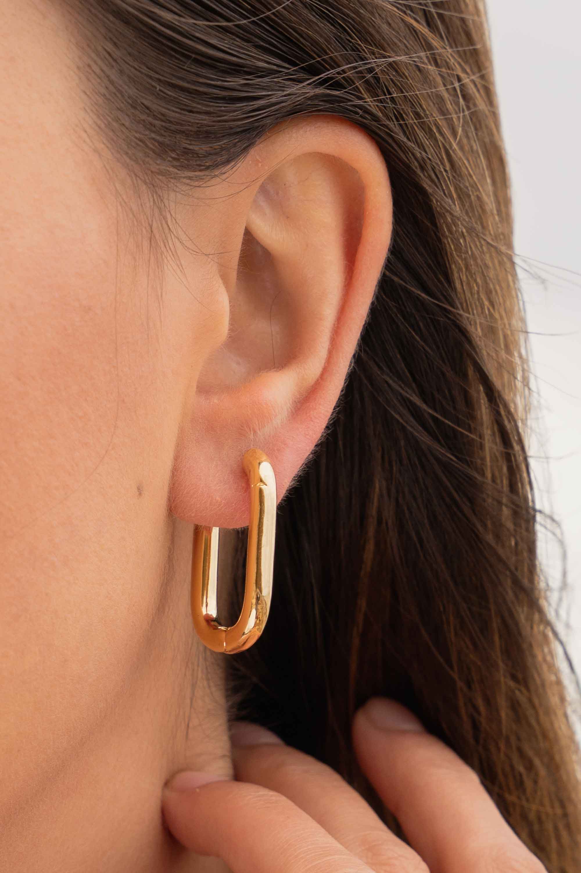 11347030-chunky-oval-geometric-chubby-statement-gold-hoop-earrings-on-body-close.jpg