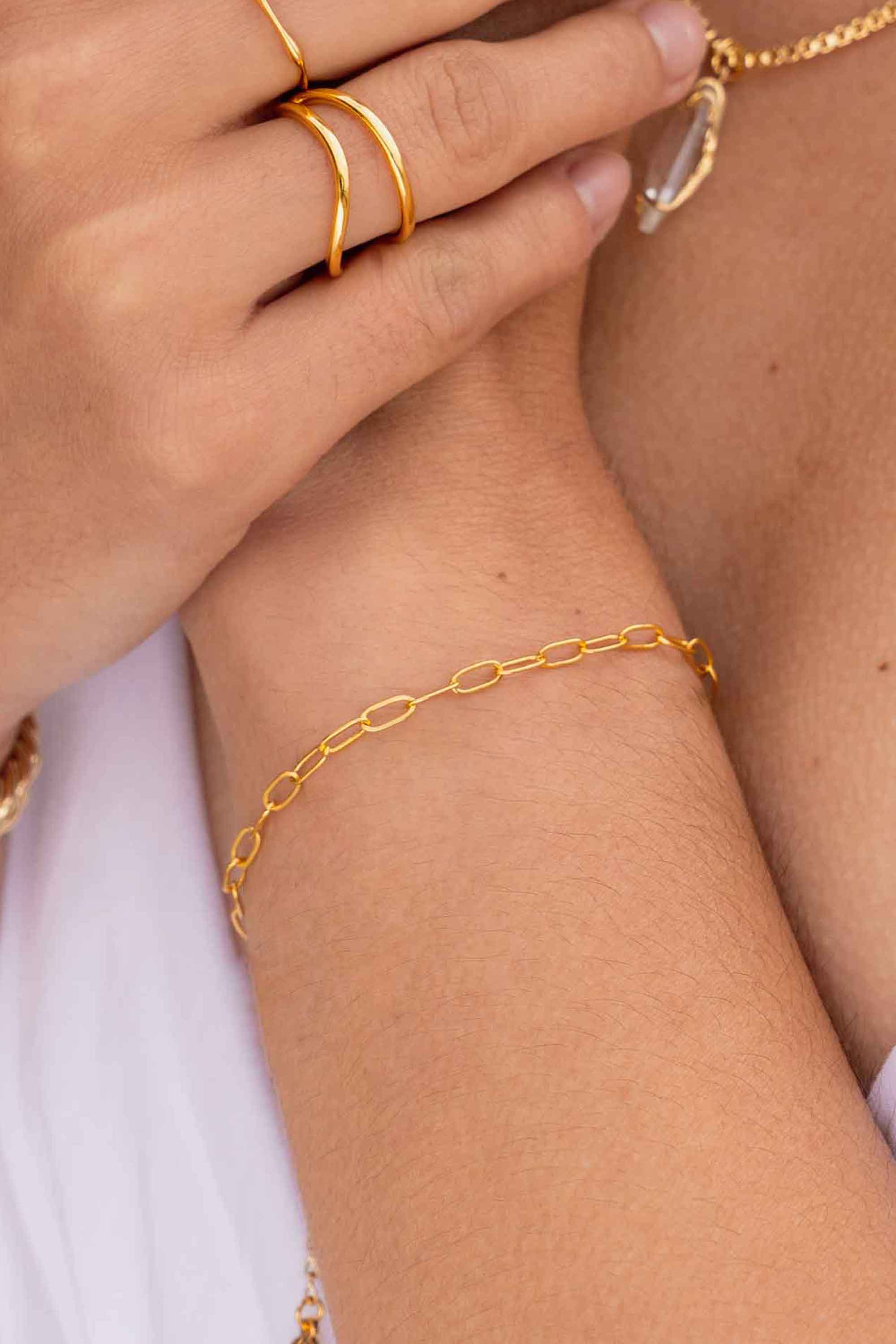 11347116-mini-oval-paperclip-delicate-gold-bracelet-on-body-2.jpg