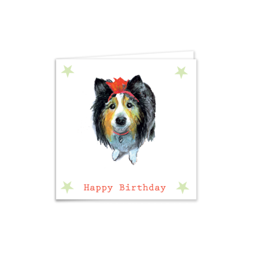 Birthday card of a collie dog wearing a bow with happy birthday written on the front of the card.